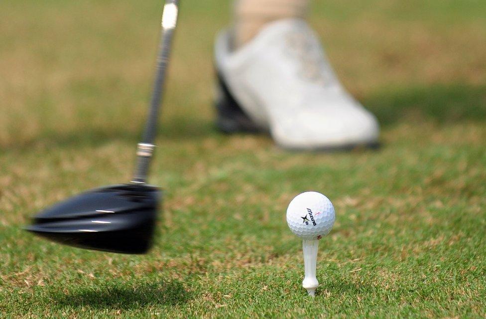 A golfer tees off at a course in Sanya on 25 October 2009 in China's southernmost tropical island province of Hainan