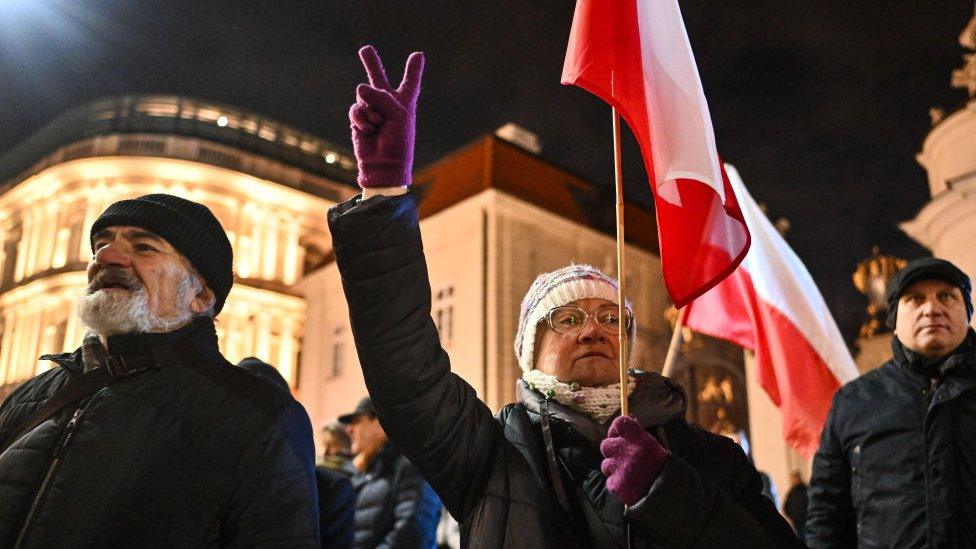 People hold banners and shout slogans as they take part in a protest against a warrant for the former Minister of the Interior of Poland in front of the Presidential Palace in Warsaw, Poland on January 09, 2024