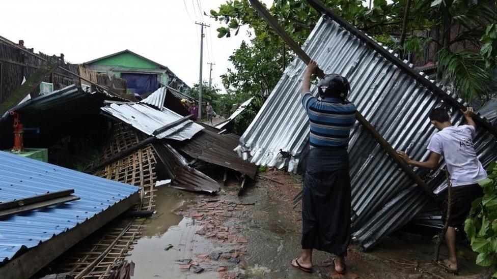 People clear debris from their house in Sittwe, Rakhine State, western Myanmar. Photo: 30 May 2017