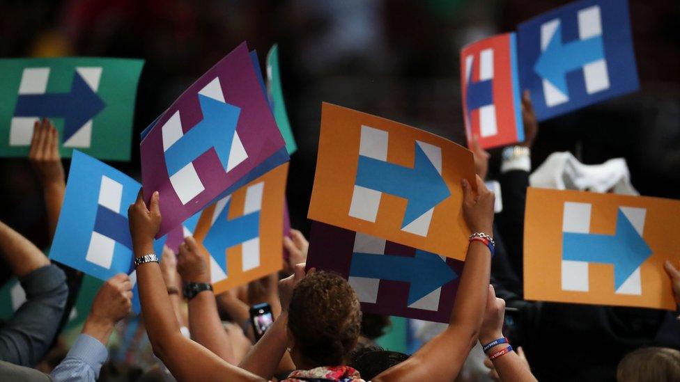 Delegates hold signs in support of Hillary Clinton, who was formally declared the Democratic presidential nominee.