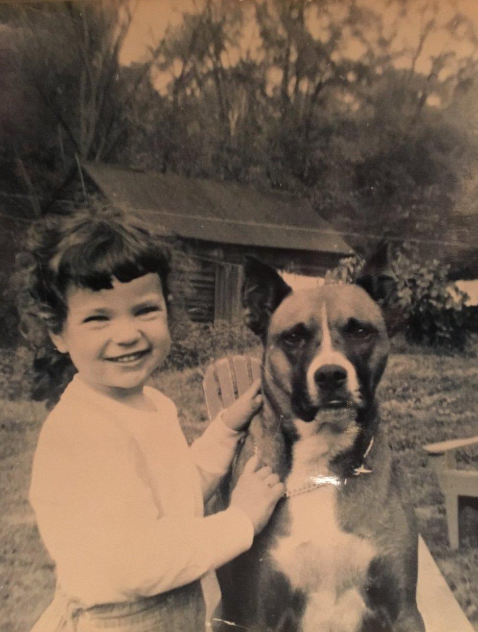 Cat Hulbert as a young girl with canine friend