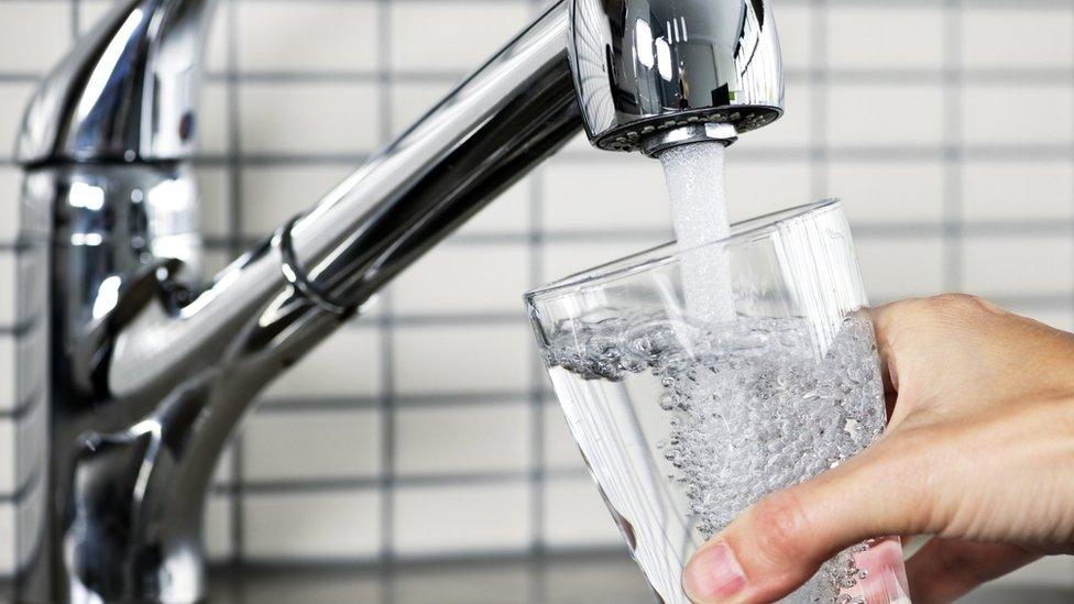 A glass being filled from a tap