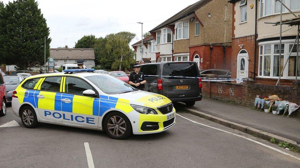 Police on Nunnery Lane near flowers left for the victim