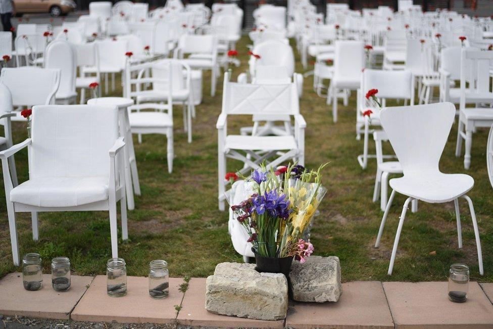 An art installation featuring 185 empty chairs on display in the Botanical Gardens in Christchurch, New Zealand