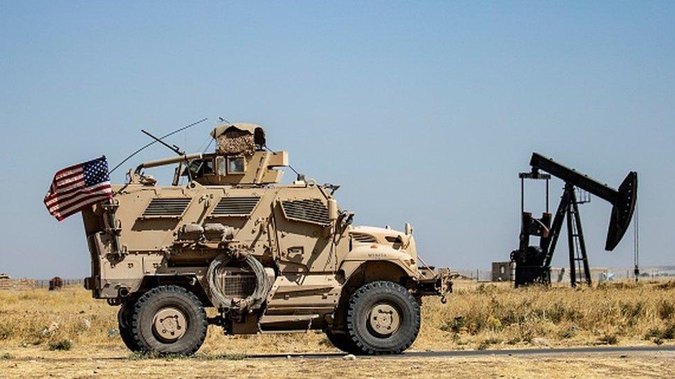 A US military vehicle patrols near oil fields in Syria