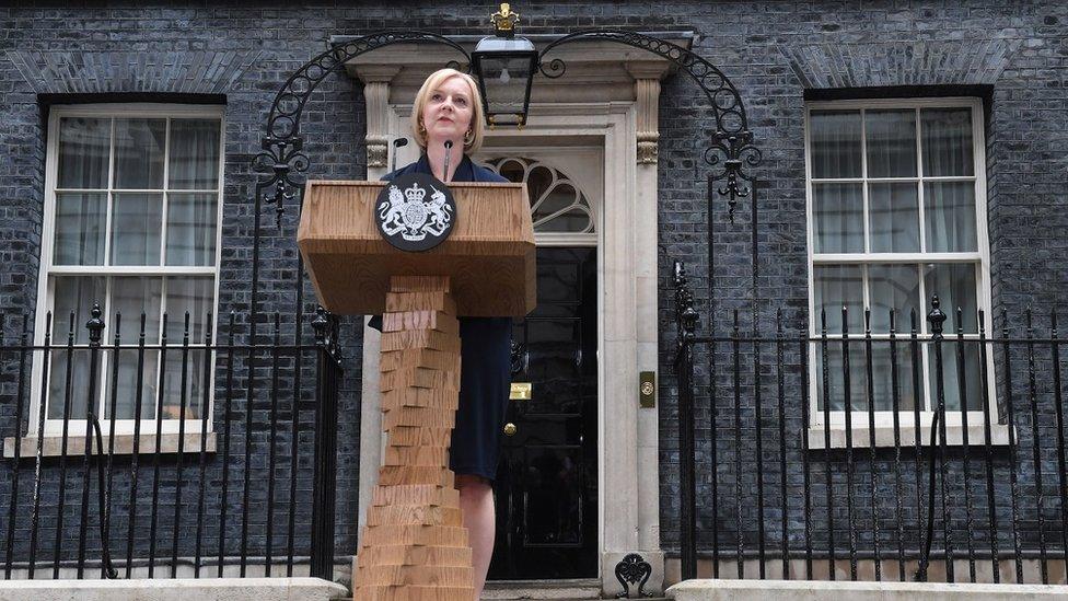 Liz Truss speaking at a lectern outside No 10