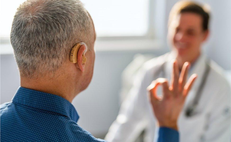 Man having hearing tested by doctor