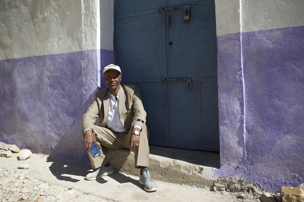 Man in front of a house