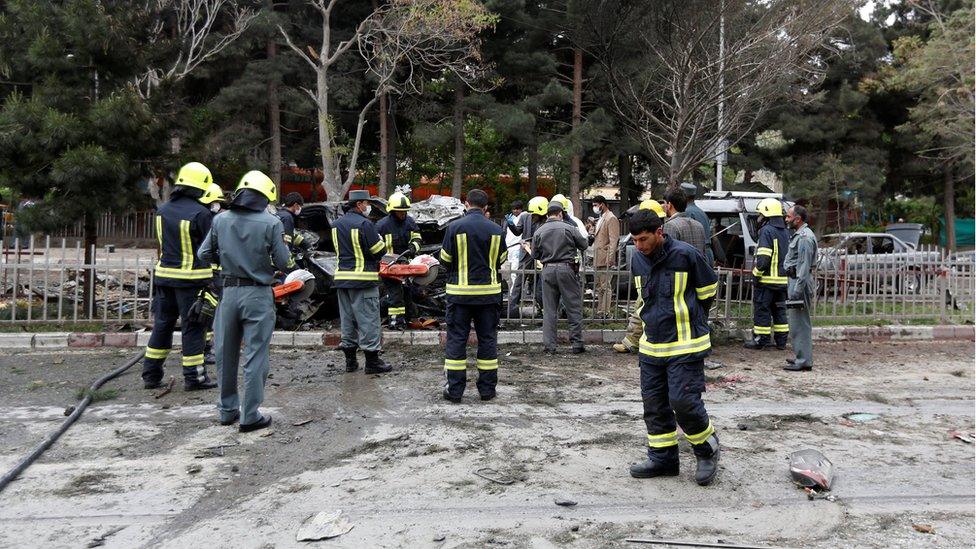 Afghan policemen inspect the site of a suicide attack in Kabul