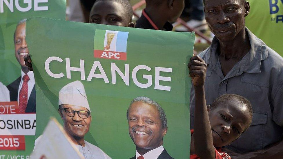 Boy holding a poster which says change