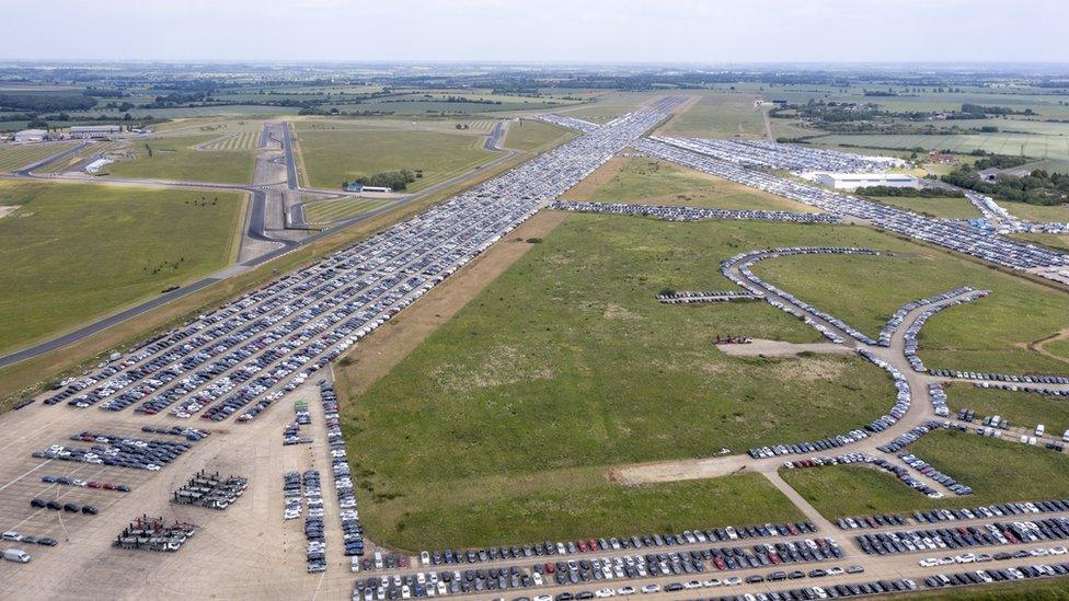 Aerial view of cars being stored on airport runways