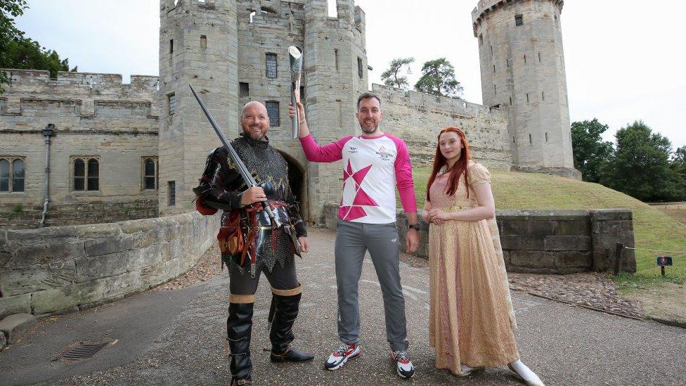 Baton bearer Jacob Balchin holds the Queen's Baton during the Birmingham 2022 Queen's Baton Relay at Warwick Castle on July 22, 2022,