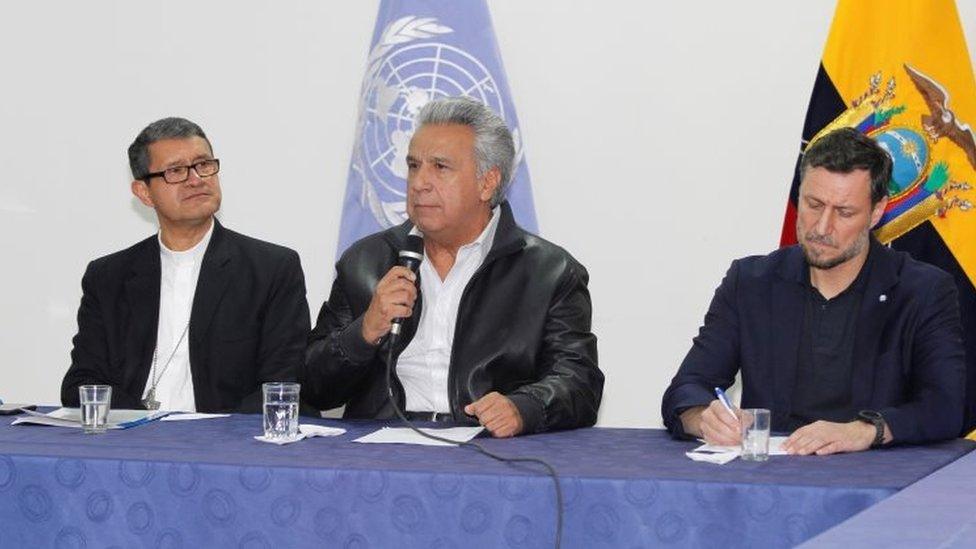 President Lenin Moreno (C) addresses the audience next to Catholic Bishop Luis Cabrera (L) and Arnaud Peral, representative of the United Nations in Ecuador, in a meeting with the leaders of indigenous communities.