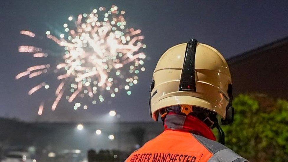 fireman looks on at firework