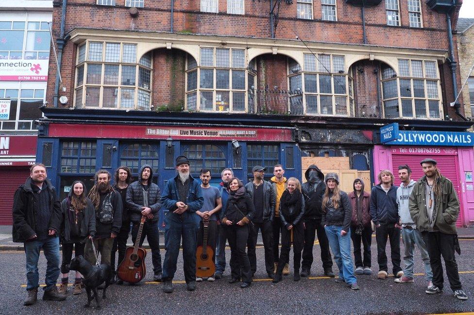 Group of people in front of the derelict pub