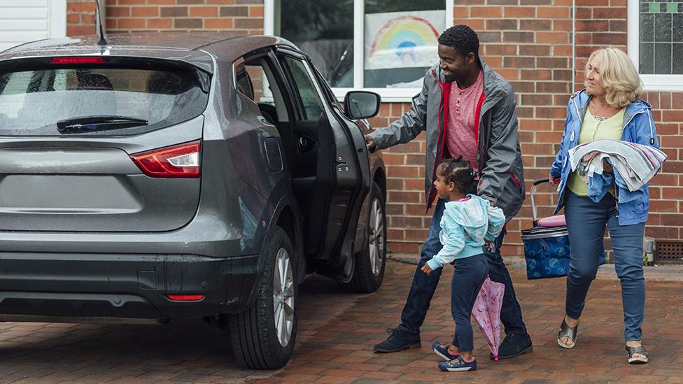 Family getting into car