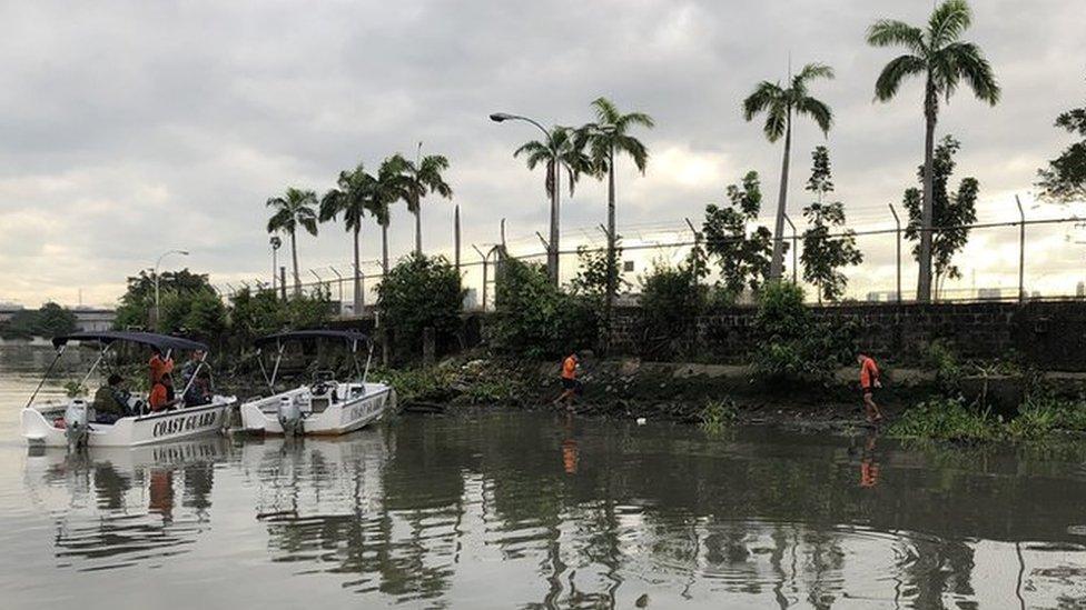 Lifeguards find a body on the Pasig River in Manila