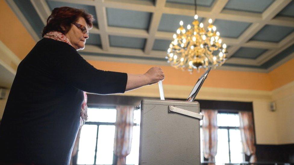 A woman casts her ballot during a referendum in Bulle, western Switzerland (18 May 2014)