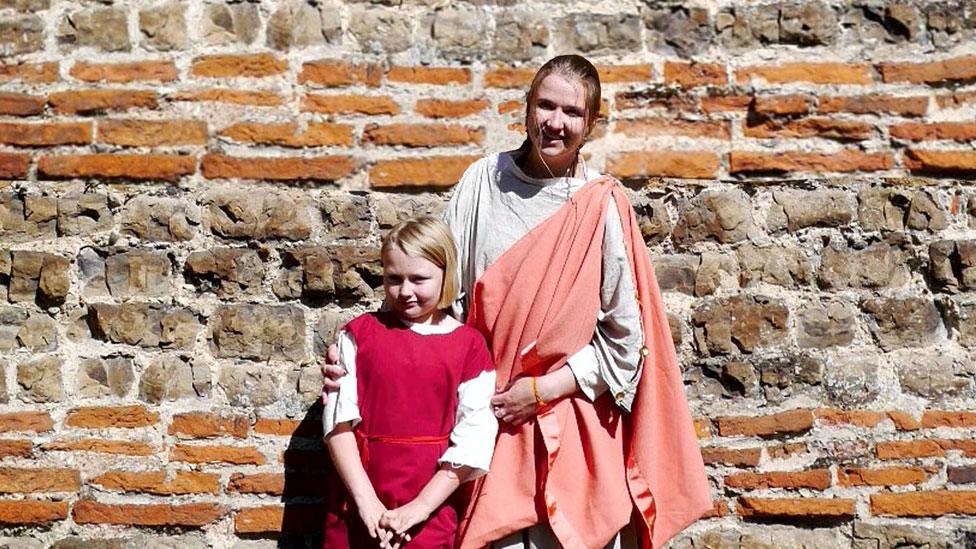 Colchester Roman wall with child and woman re-enactors