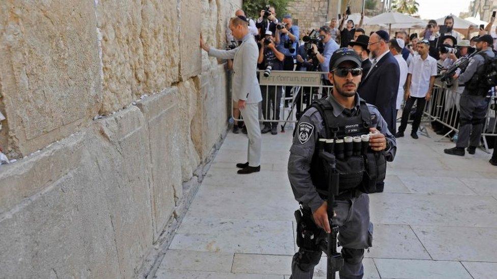 An Israeli policeman standing guard as the Duke of Cambridge visits the Western Wall