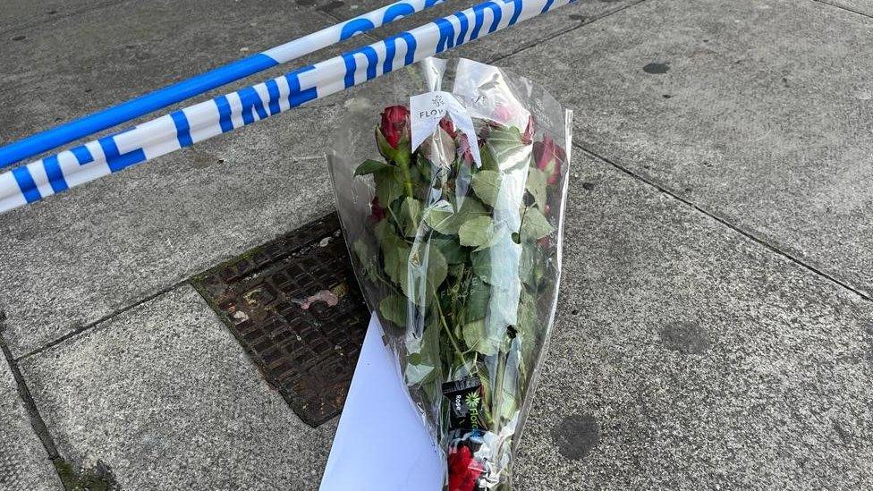 Flowers under police tape