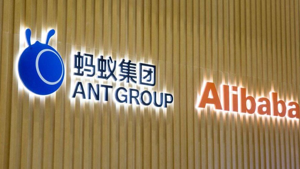 Alibaba and Ant Group logos on a wall