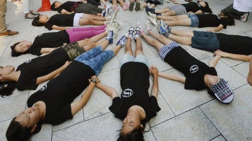 Children stage a die-in in front of the Atomic Bomb Dome in Hiroshima