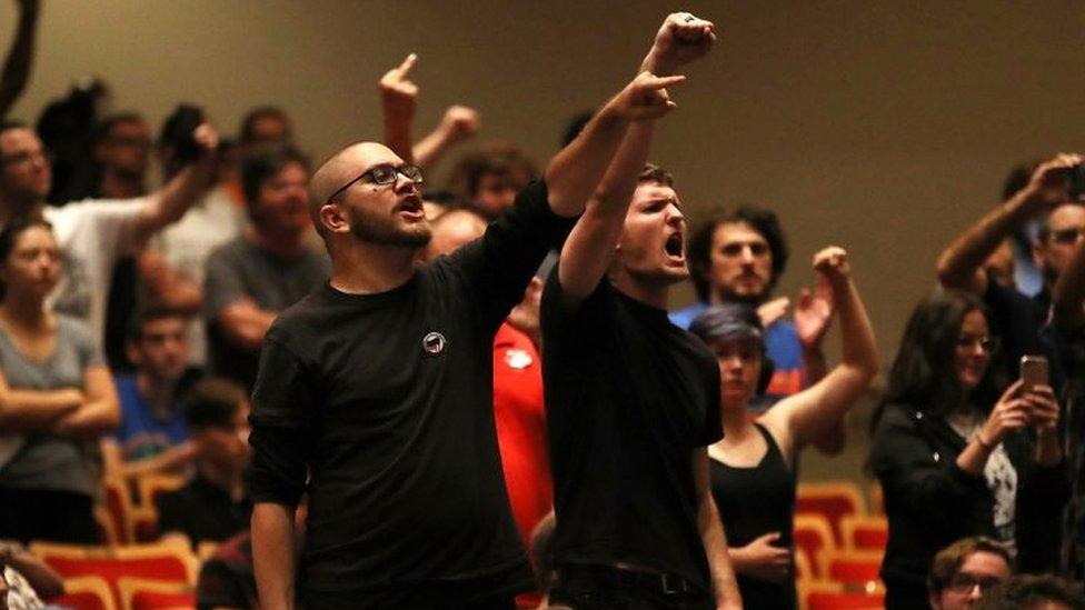 Members of a crowd at white nationalist Richard Spencer's speech at University of Florida raise fists and chanted in Gainesville, Florida.