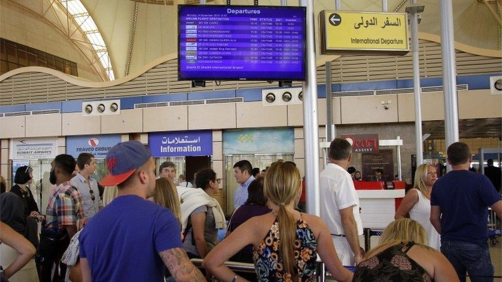 Passengers check the departure information at Sharm el-Sheikh airport