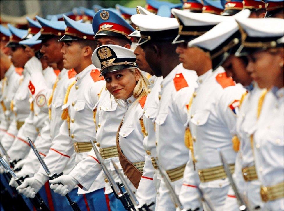 An honour guard stands out as she smiles amongst the other guards