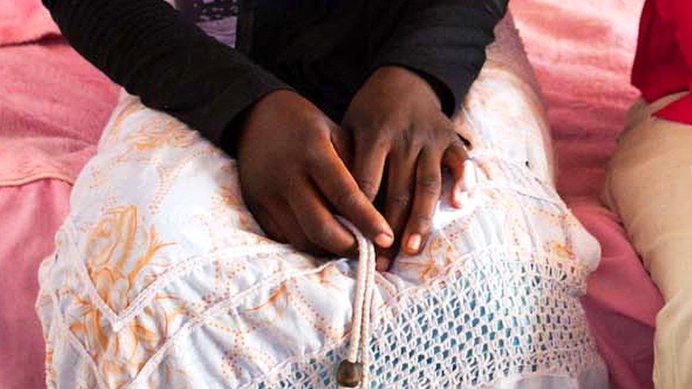 The hands of a 16-year-old who was married at the age of 13