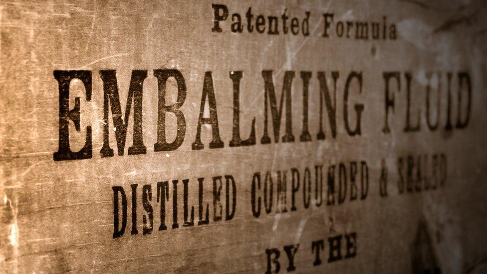 Box with the text 'embalming fluid' printed across it