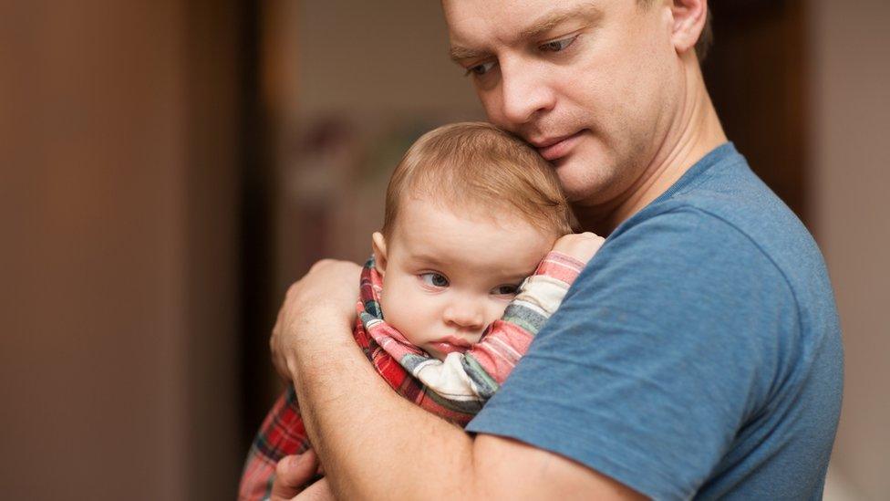 Man holding baby