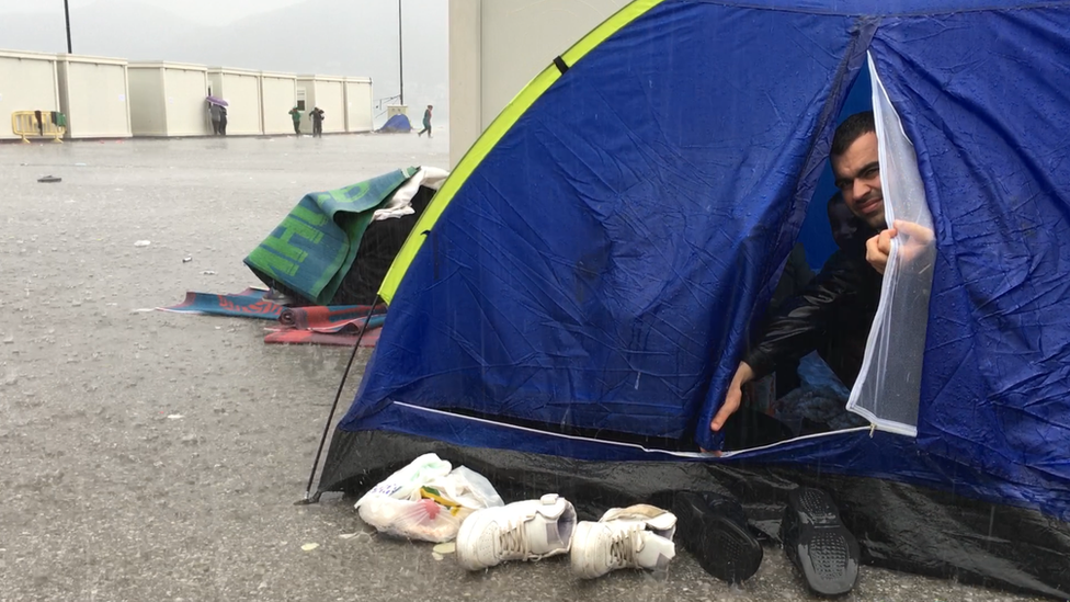 Migrant man in tent in rain on Samos (October 2015)