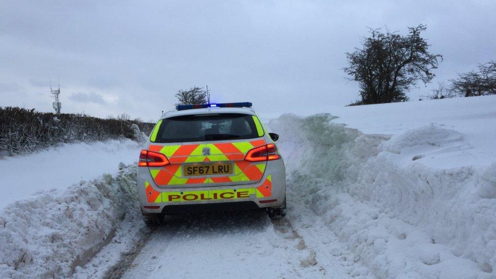 Police car in snow drift