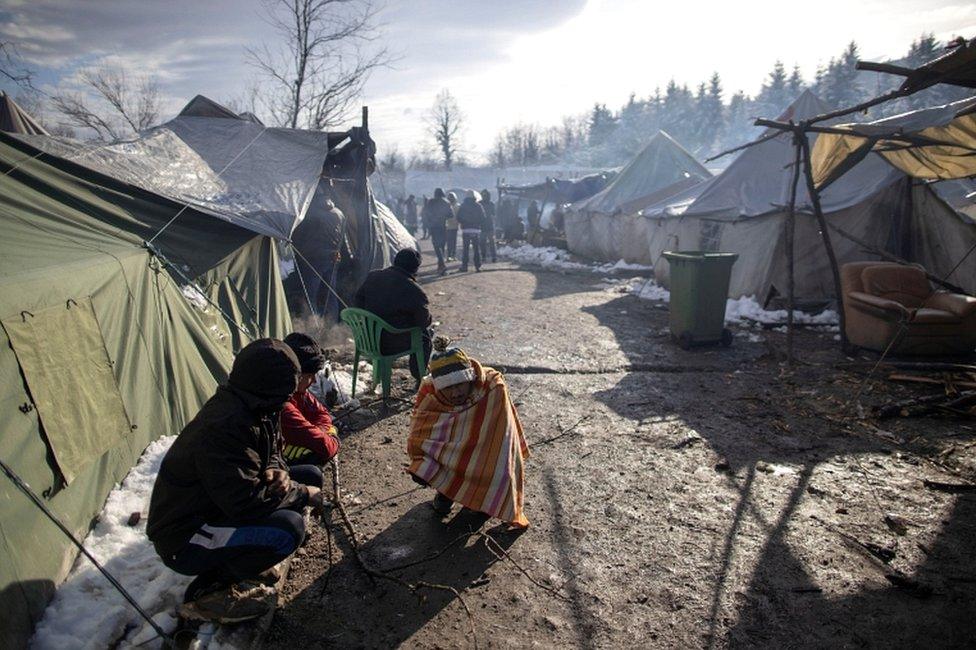 Migrants warm up at the migrant camp in Vucjak near Bihac, Bosnia and Herzegovina, on 6 December 2019