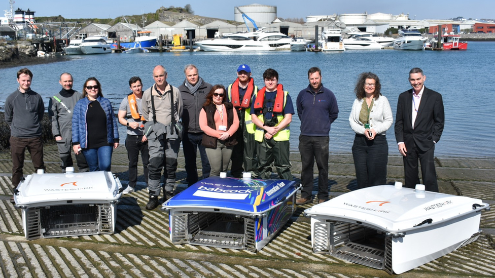 Group photo of experts from industry and academia are working together to enhance the technology behind the waste robots