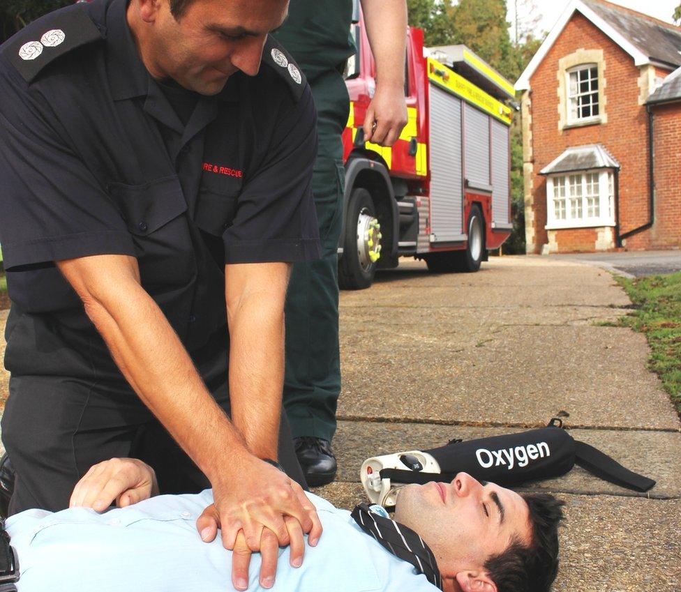 Firefighter treating a patient, posed by a model