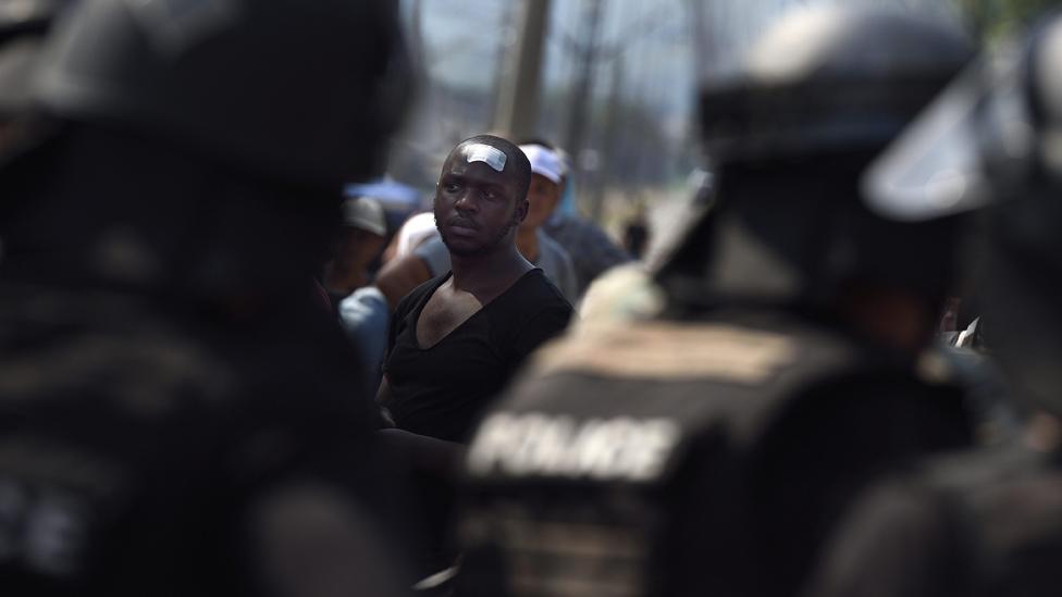 A group crosses the border, controlled by Macedonian police, between the Former Yugoslav Republic of Macedonia and Greece, near the town of Gevgelija, 26 August 2015.