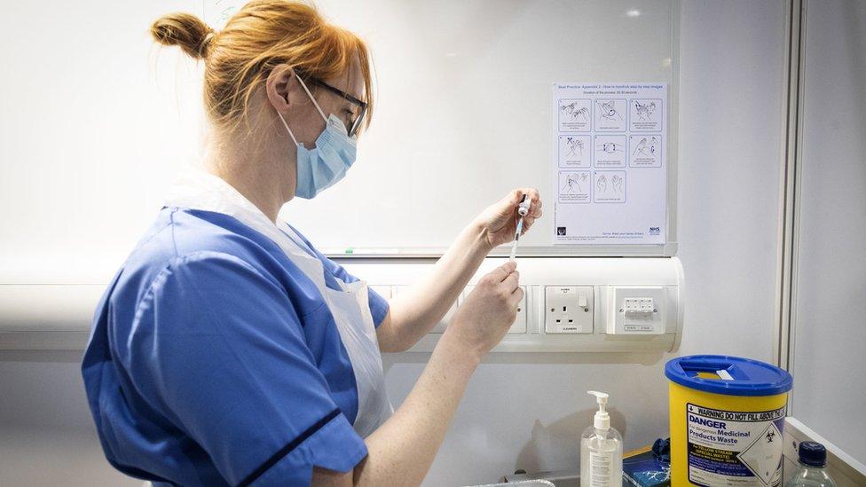 A nurse preparing a coronavirus vaccine