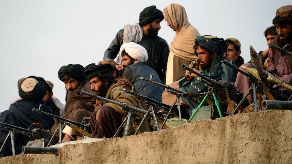 A file picture taken on November 3, 2015, shows Afghan Taliban fighters listening to Mullah Mohammad Rasool Akhund (unseen), the newly appointed leader of a breakaway faction of the Taliban, at Bakwah in the western province of Farah