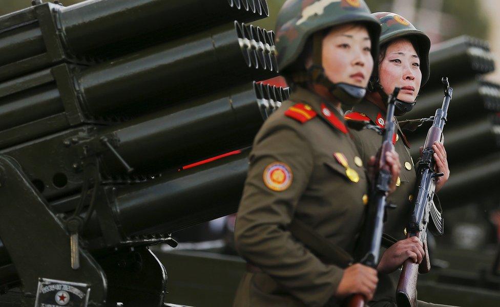 A soldier cries as her vehicle, carrying rocket launchers, takes part in the parade celebrating the 70th anniversary of the founding of the ruling Workers' Party of Korea, in October