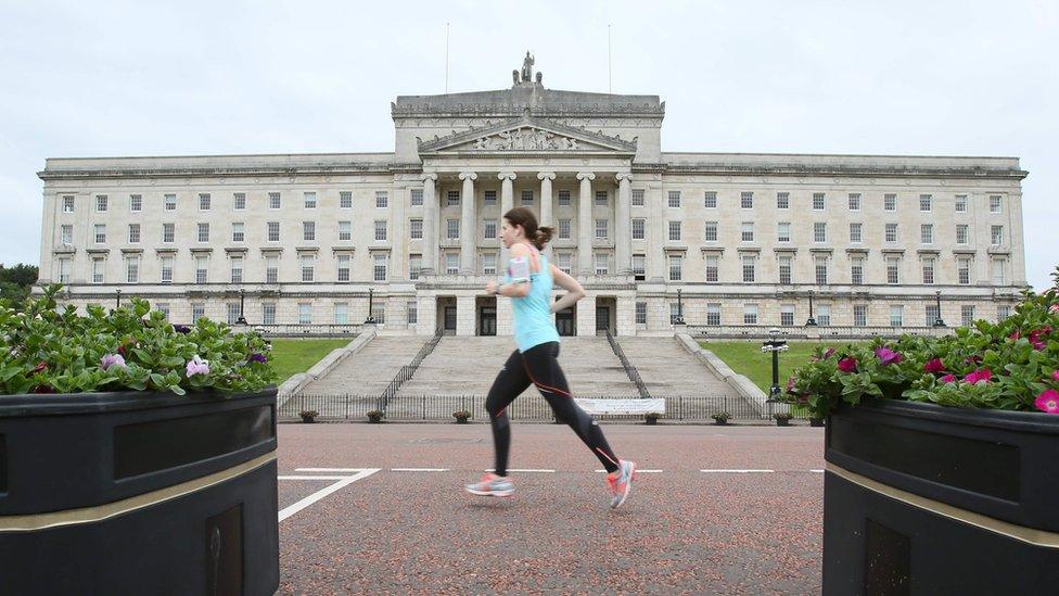 A runner goes past Parliament Buildings at Stormont