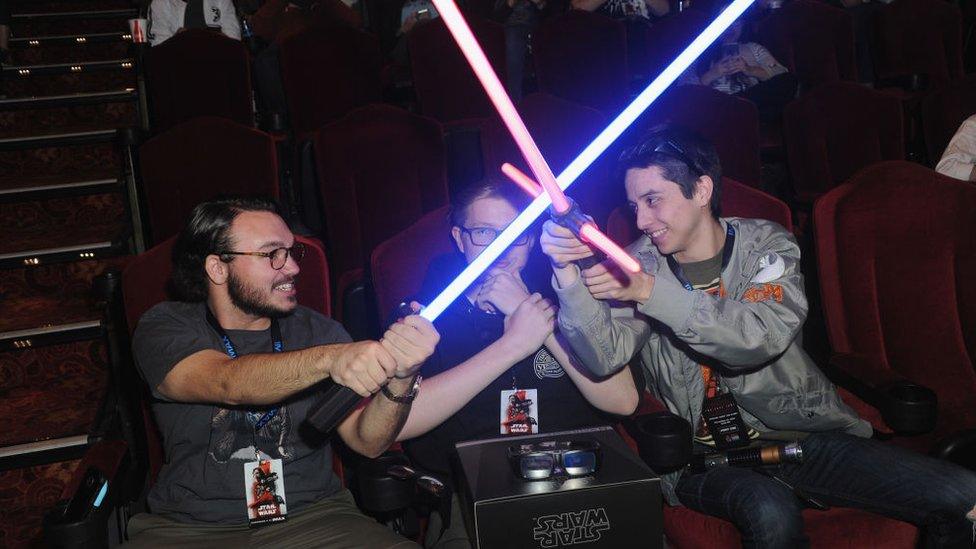 fans-having-a-lightsaber-fight-in-the-cinema-at-the-star-wars-premiere.