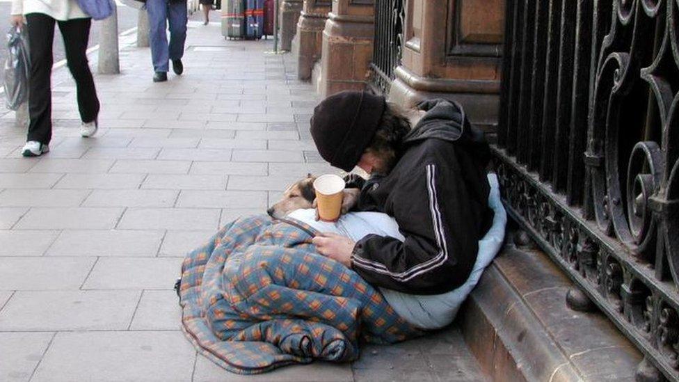 A homeless person begging