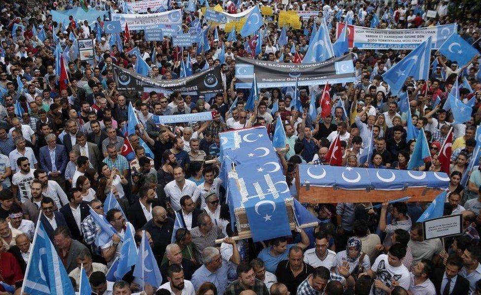 Uighurs living in Turkey and their supporters, some carrying coffins representing Uighurs who died in China's far-western Xinjiang Uighur region, chant slogans