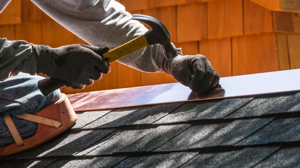 Stock image of a roofer working.