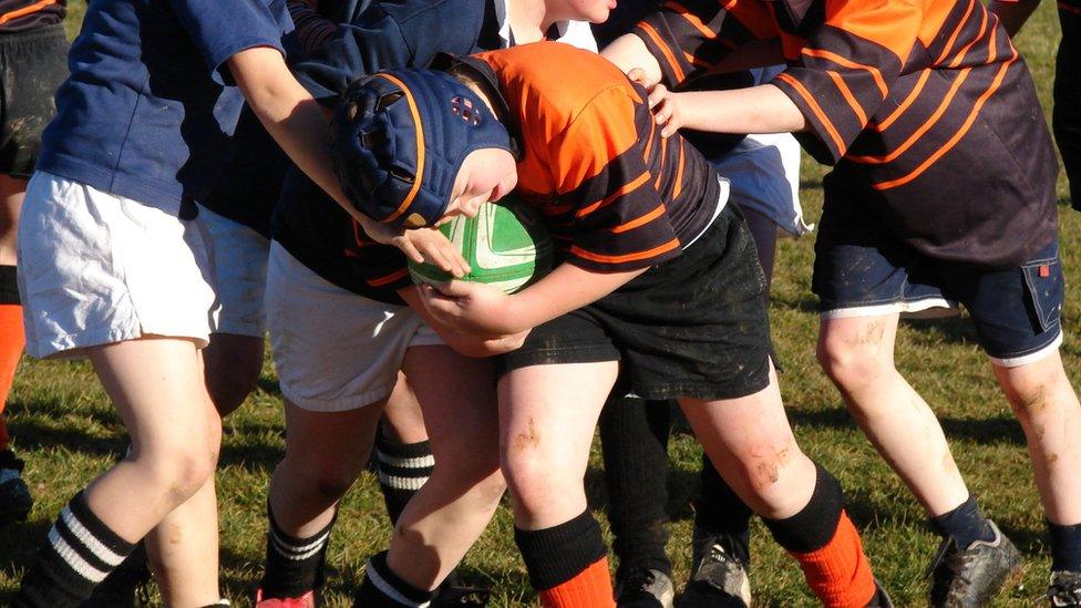 Boys playing rugby