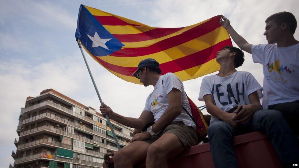 Demonstrators gather on Meridiana street as they wave "Estelada" flags (pro-independence Catalan flags) during celebrations of Catalonia"s National Day