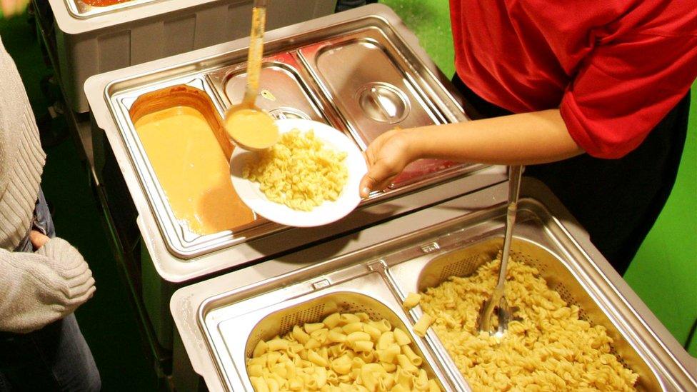 A close-up of food being served in a canteen